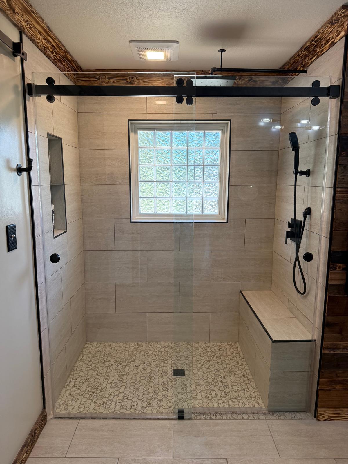 Glass shower enclosure with matte black hinges and handle