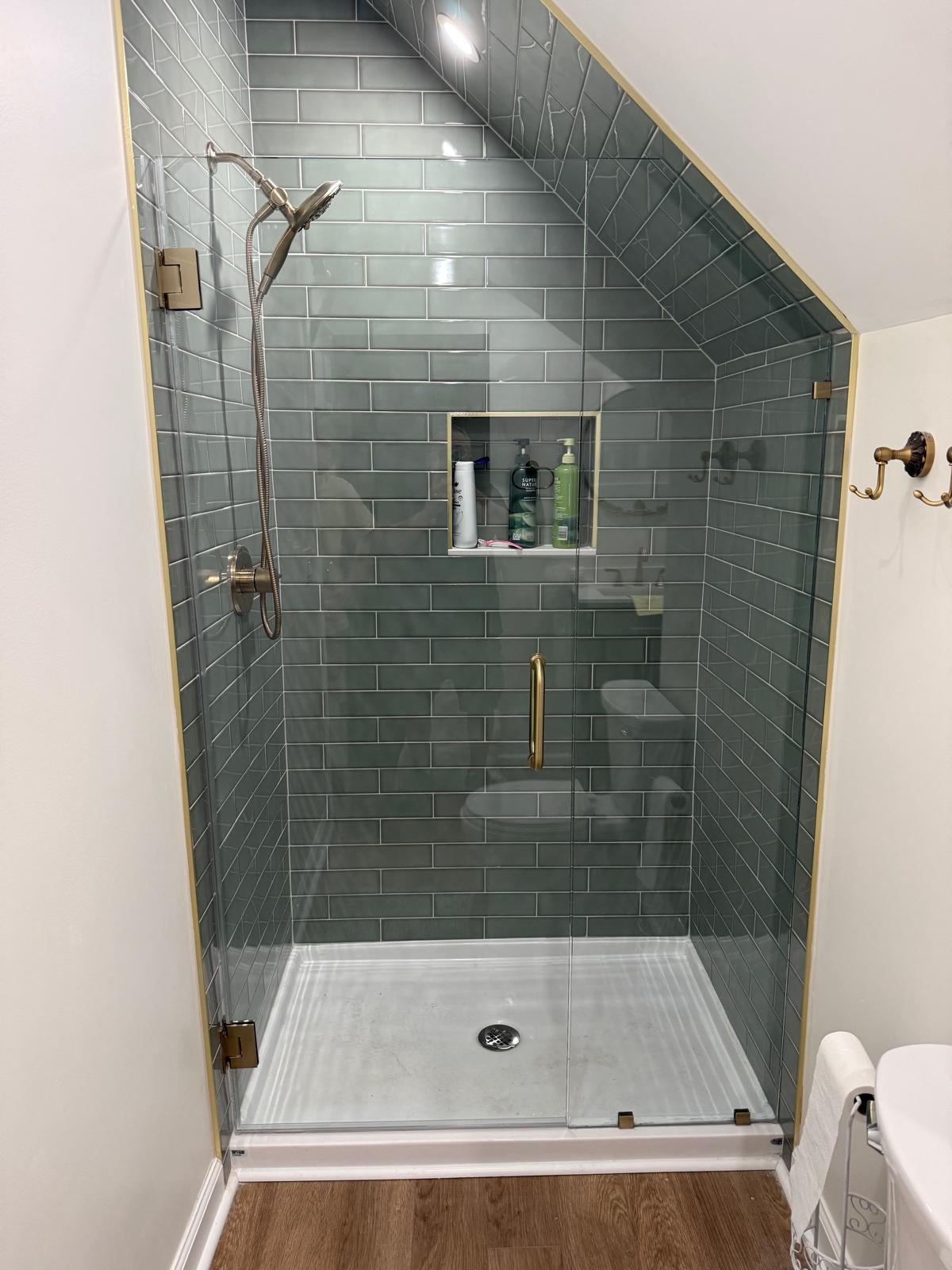 Custom frameless shower glass cut for an angled ceiling