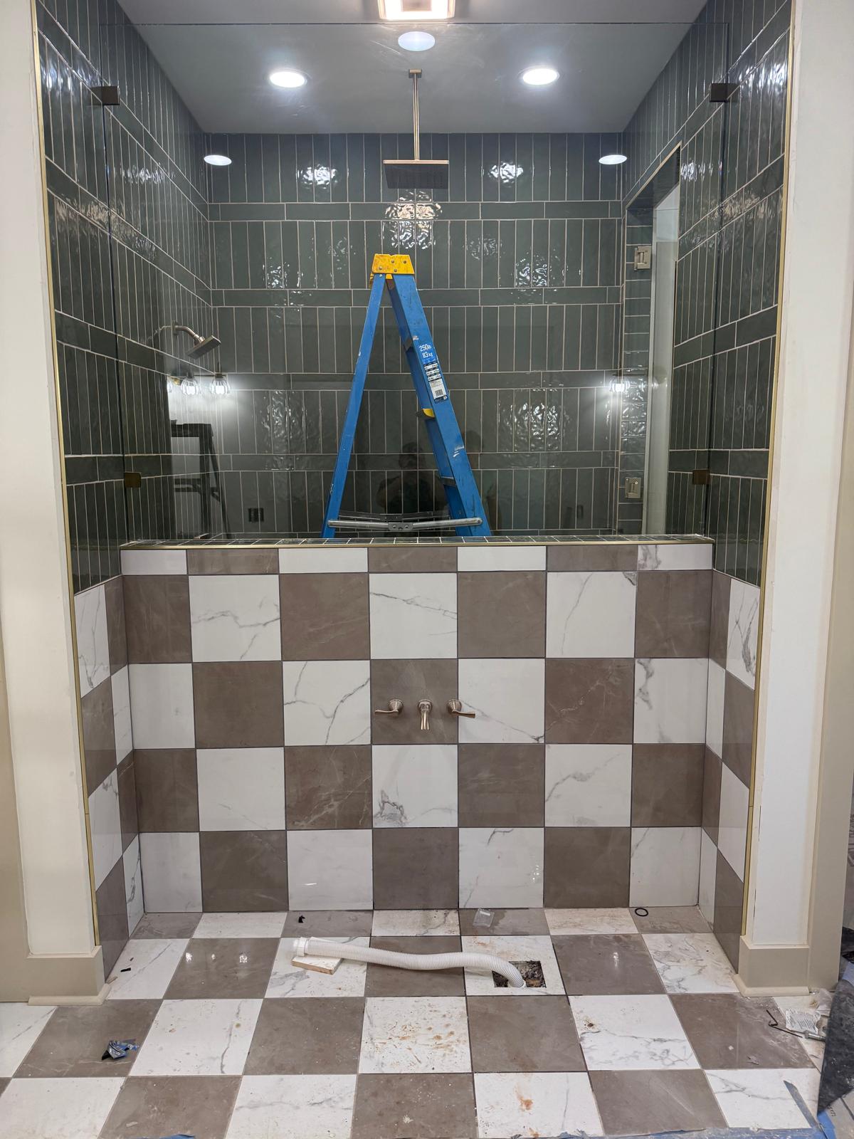 Shower enclosure installation in progress with a tiled wall